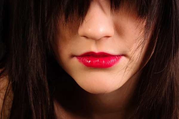 Lips of an attractive girl with her hair hiding her eyes — Stock Photo, Image