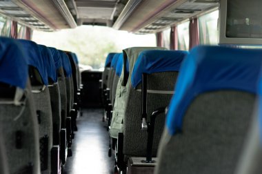 Interior of a bus with many seats clipart