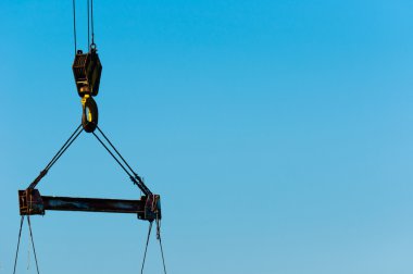 Industrial crane against blue sky clipart