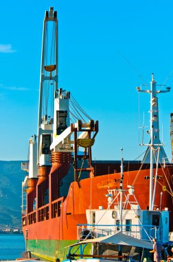 Big transportation boat at the bay against blue sky clipart