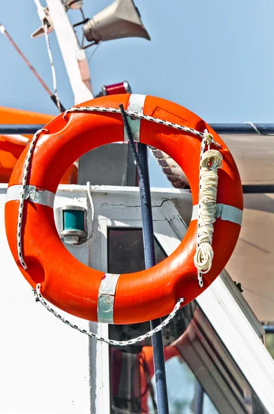 Red bouy on a boat ready to save lives — Stock Photo, Image