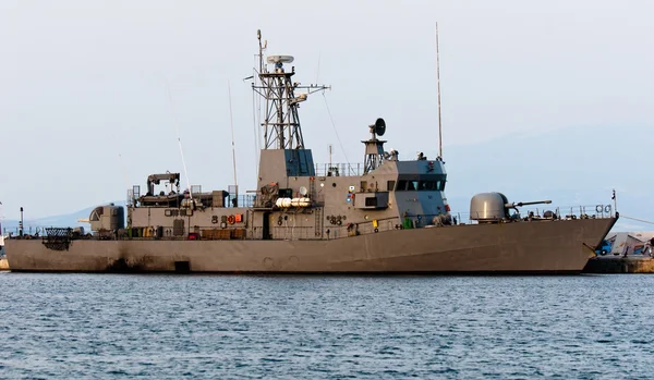 stock image Big battle ship in the dock against blue sky and mountains