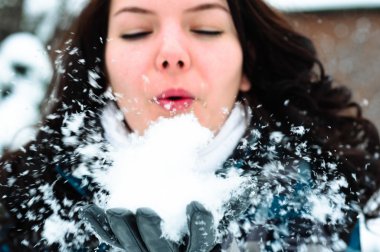 Woman blewing snow in my face clipart