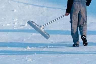 Male worker cleaning the road from the snow clipart