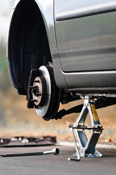 Auto senza pneumatico sulla strada — Foto Stock