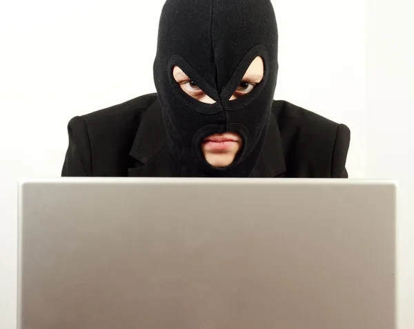 Woman internet hacker using laptop to rule the world — Stock Photo, Image