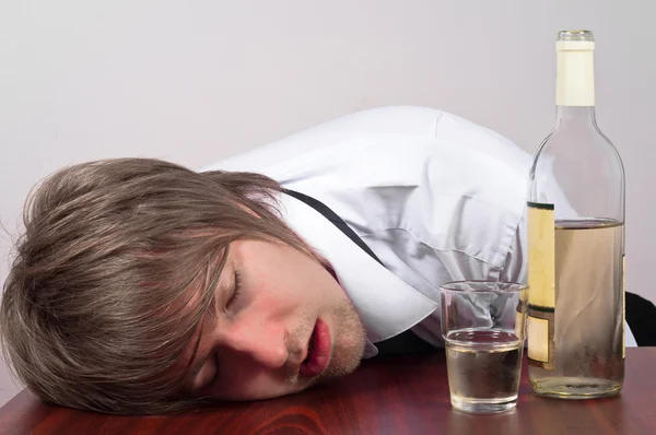 Young man with alcohol — Stock Photo, Image