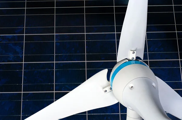 Wind turbine against solar panel — Stock Photo, Image