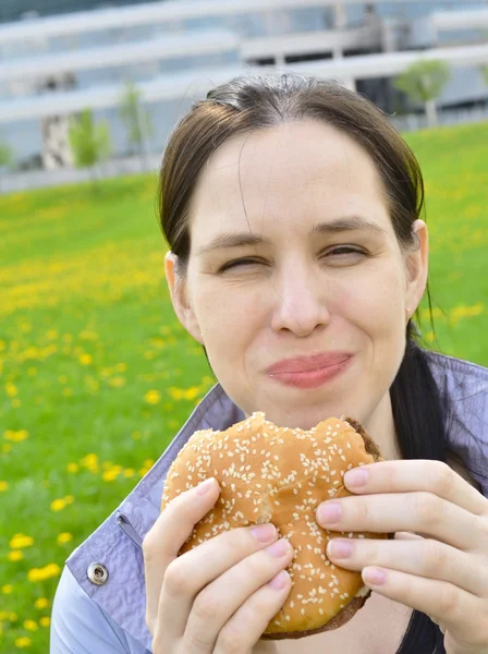 stock image Happy beautuful girl eating hamburger.