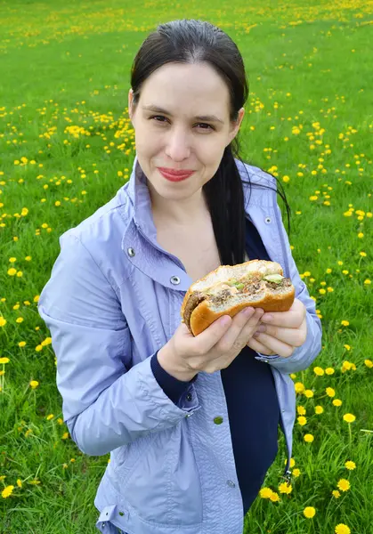 stock image Happy beautuful girl eating hamburger.