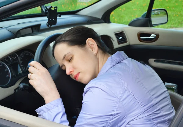 stock image Young girl sleeps in her car.