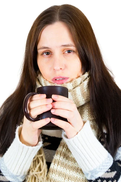 stock image Young woman caught cold, wrapped up in blanket, drinking somethi