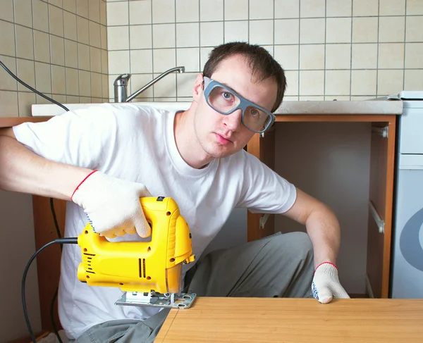 stock image The man with an electro fret saw