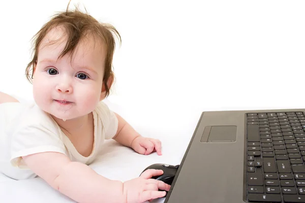 stock image Little baby girl with a computer on a white background