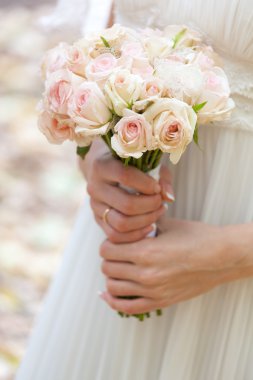 Wedding bouquet at bride's hands clipart