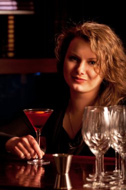 Beautiful woman at the cocktail bar clipart