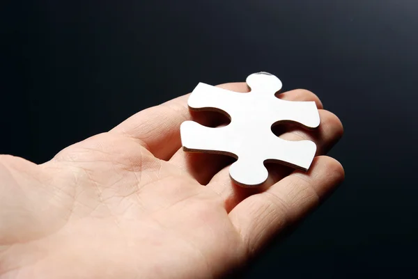 stock image Hand holding a puzzle piece