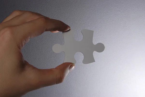 Hand holding a puzzle piece — Stock Photo, Image