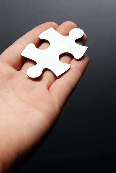 Hand holding a puzzle piece — Stock Photo, Image