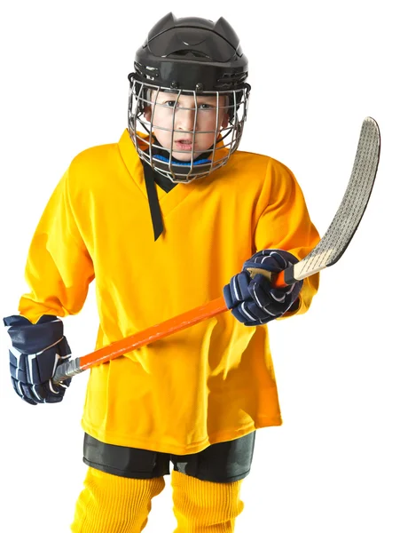 Roztomilý chlapec v uniformě žlutou hokej — Stock fotografie