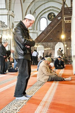 Men praying in a mosque clipart