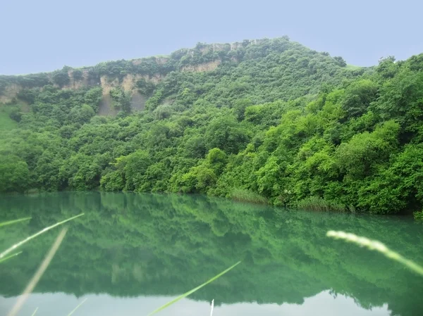 stock image Small lake between the caucasus mountains summertime