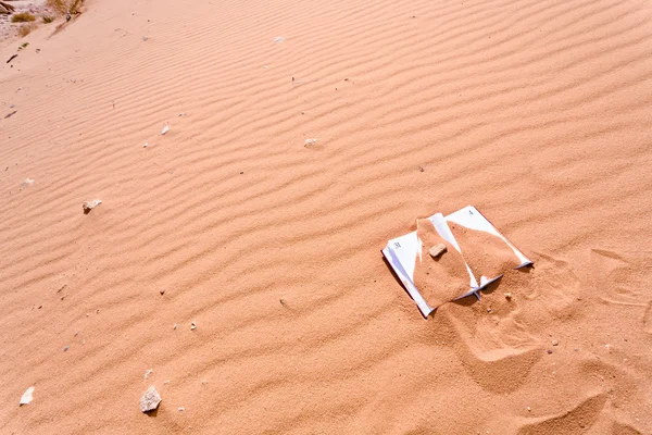 Notebook in red sand dune of dessert — Stock Photo, Image