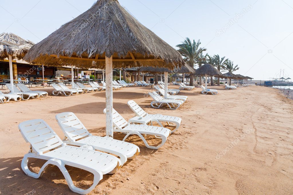 Plastic beach beds on coral bay in Aqaba