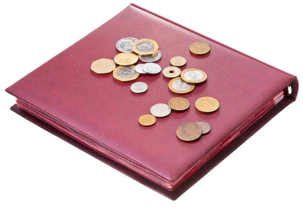 Different coins on red numismatics album — Stock Photo, Image