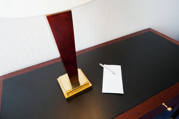 Envelope on table with electric lamp — Stock Photo, Image
