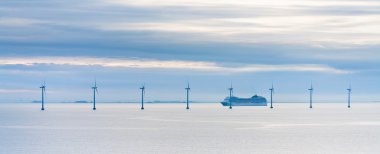 Offshore wind farm at early morning clipart