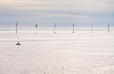 Offshore wind farm at early morning clipart