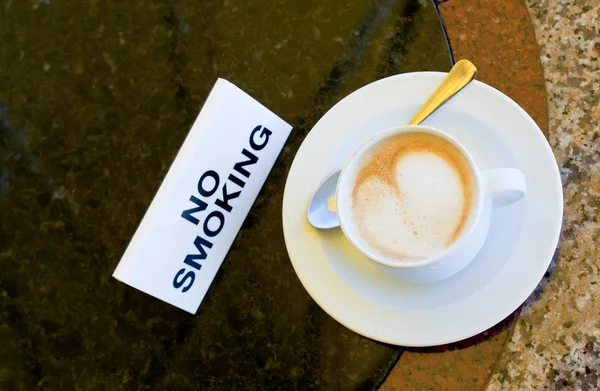 stock image Cup of cappuccino on no-smoking table