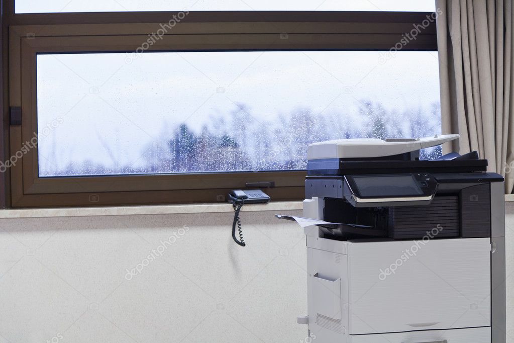 Big grey copier in grey office