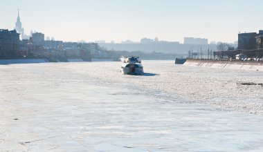 Iceboat on frozen Moscow river in sunny winter day clipart