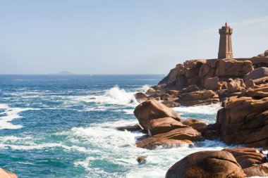 Lighthouse in the rocks on Brittany Pink Granite Coast in France clipart