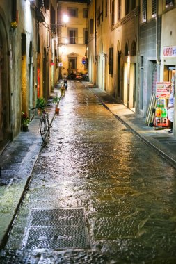 Medieval street in Florence Italy at night clipart