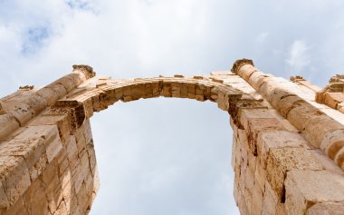 Arch and column in antique city of Gerasa Jerash clipart