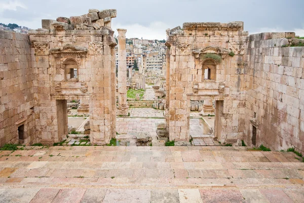 Vista a través del antiguo templo de Artemisa en la antigua ciudad de Gerasa a la moderna Jerash —  Fotos de Stock