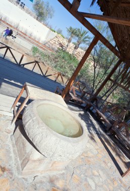 Font-stone in baptism site on Jordan river clipart