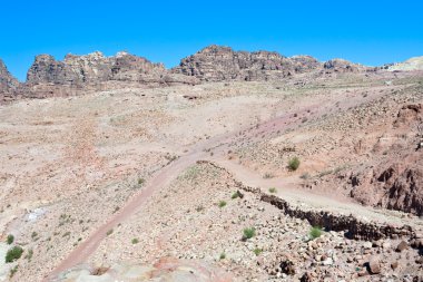 Crossroads in stone waste land of Petra clipart