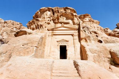 Ancient tomb near the entrance in Little Petra clipart