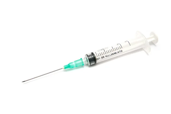 Syringe with a green cap — Stock Photo, Image