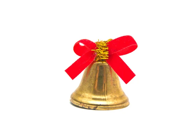 Campana dorada con cinta roja sobre blanco — Foto de Stock