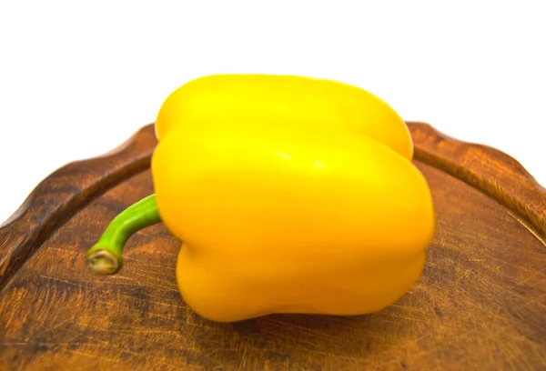 Single yellow pepper on cutting board — Stock Photo, Image