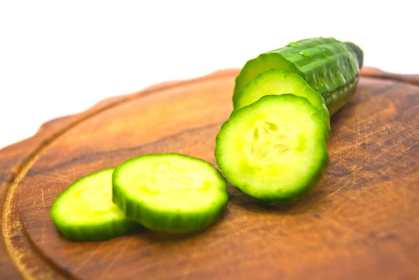 Cucumber on cutting board on white — Stock Photo, Image
