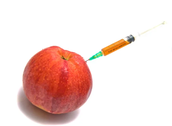 Red apple and syringe on white — Stock Photo, Image
