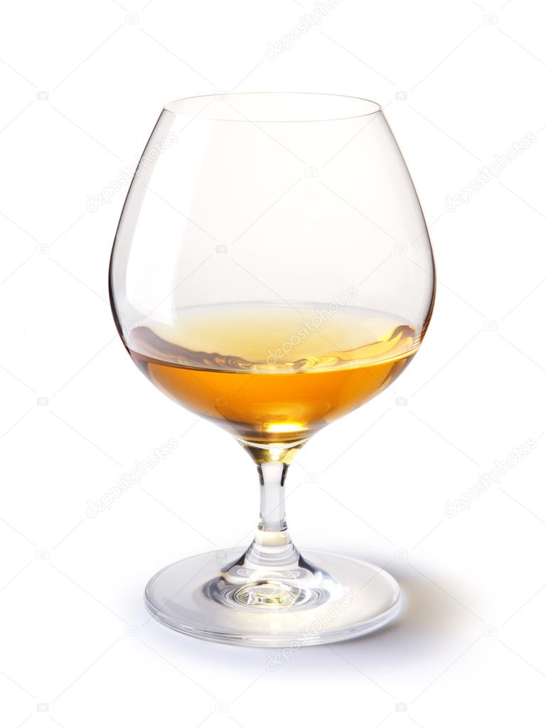 Cognac glass with gold cognac on a white