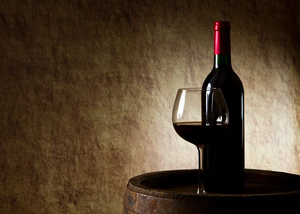 Red wine, bottle, glass and old barrel — Stock Photo, Image