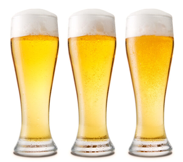 Beer into glass isolated on white.